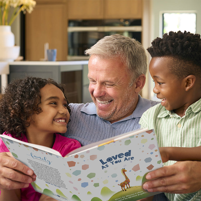 multi-racial christian family, grandfather reading "loved as you are" by steven cohen to adopted grandchildren