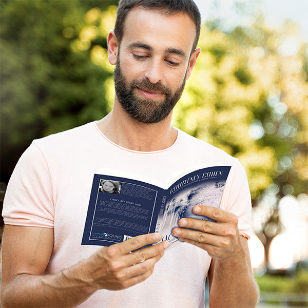 smiling latin christian man reading the sacred shadow in park